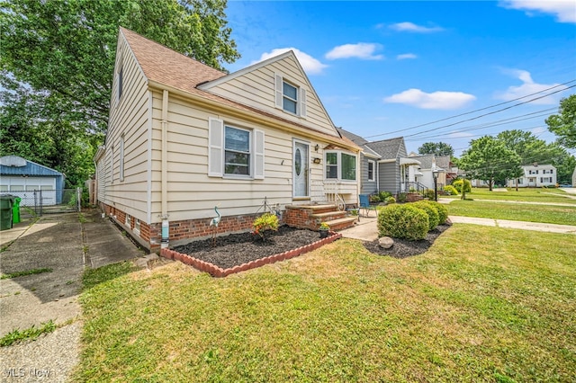 1743 Silver St, Wickliffe, OH 44092 - view of front facade with a front yard, an outbuilding, and a detached garage