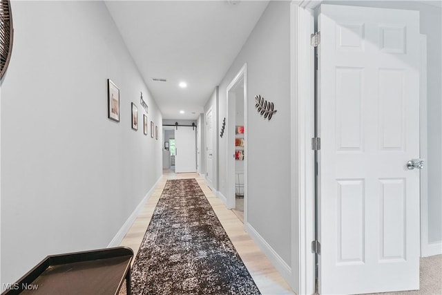 4933 Lear Nagle Rd, North Ridgeville, OH 44039 - hallway with recessed lighting, light wood-type flooring, and a barn door