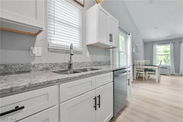 4933 Lear Nagle Rd, North Ridgeville, OH 44039 - kitchen with dishwasher, white cabinets, lofted ceiling, light wood-style floors, and light stone counters