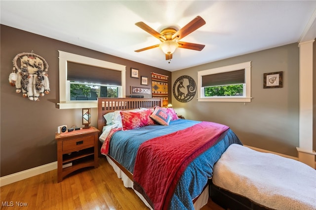 25171 Doe Dr, North Olmsted, OH 44070 - bedroom with multiple windows, wood finished floors, and a ceiling fan