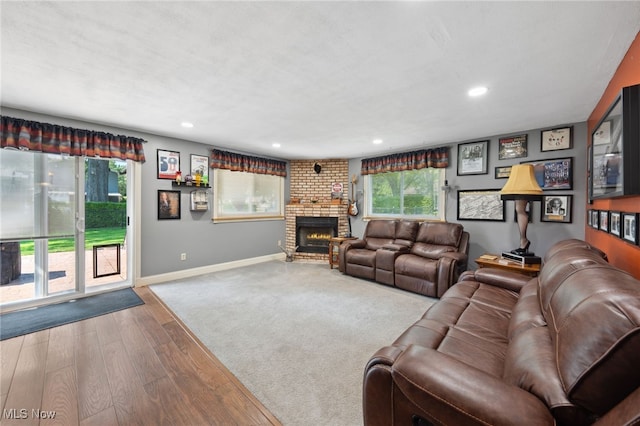 25171 Doe Dr, North Olmsted, OH 44070 - living area with wood finished floors, recessed lighting, and a brick fireplace