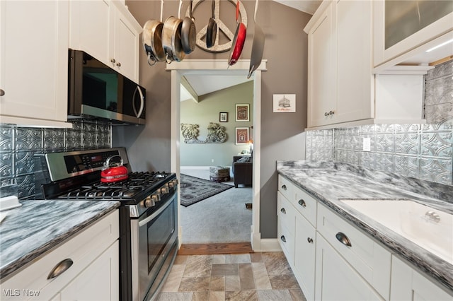 25171 Doe Dr, North Olmsted, OH 44070 - kitchen featuring stainless steel appliances, decorative backsplash, and white cabinetry