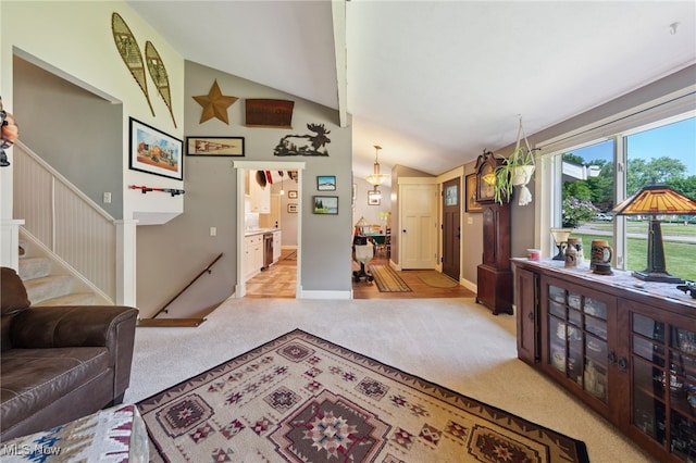 25171 Doe Dr, North Olmsted, OH 44070 - living room with light colored carpet, stairway, and high vaulted ceiling