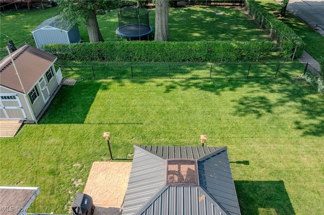 25171 Doe Dr, North Olmsted, OH 44070 - fenced backyard featuring a trampoline and a storage unit