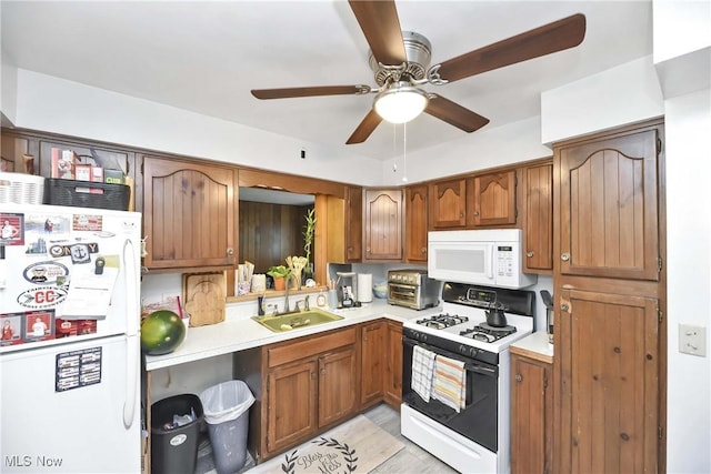 4480 W 224th St, Fairview Park, OH 44126 - kitchen with white appliances, light countertops, brown cabinets, and a ceiling fan