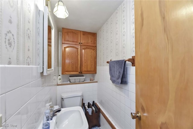 4480 W 224th St, Fairview Park, OH 44126 - bathroom featuring wallpapered walls, tile walls, and a wainscoted wall