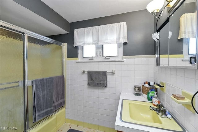 4480 W 224th St, Fairview Park, OH 44126 - bathroom featuring vanity, tile walls, bath / shower combo with glass door, and a wainscoted wall