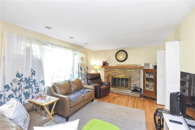 4480 W 224th St, Fairview Park, OH 44126 - living area featuring light wood-type flooring and a stone fireplace