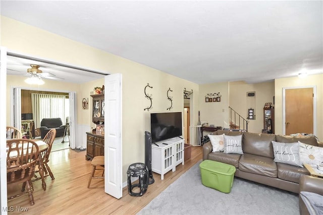 4480 W 224th St, Fairview Park, OH 44126 - living room with light wood-type flooring, ceiling fan, and stairway