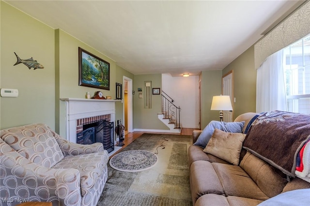 4959 Anderson Rd, Lyndhurst, OH 44124 - living room with wood finished floors, stairway, and a brick fireplace