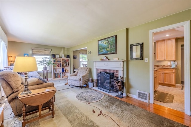4959 Anderson Rd, Lyndhurst, OH 44124 - living area featuring a brick fireplace and light wood-style floors