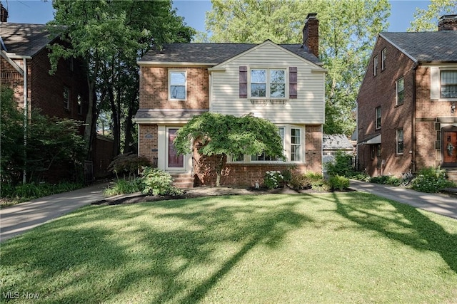 2383 Saybrook Rd, University Heights, OH 44118 - view of front of home featuring brick siding, a front lawn, a chimney, and entry steps