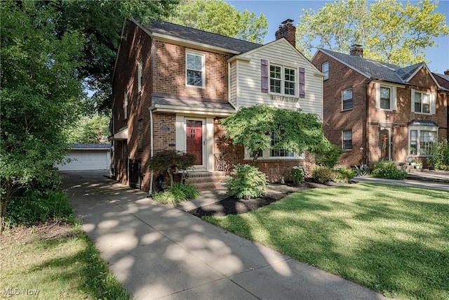 2383 Saybrook Rd, University Heights, OH 44118 - view of front of property with brick siding, an outdoor structure, a detached garage, and a front yard