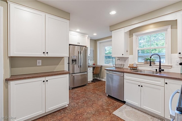 2383 Saybrook Rd, University Heights, OH 44118 - kitchen featuring stainless steel appliances, white cabinetry, recessed lighting, dark countertops, and tasteful backsplash
