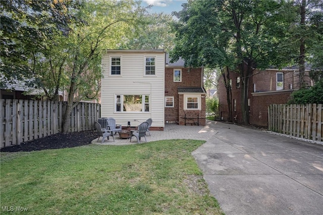 2383 Saybrook Rd, University Heights, OH 44118 - back of house featuring a fire pit, a fenced backyard, and a patio area