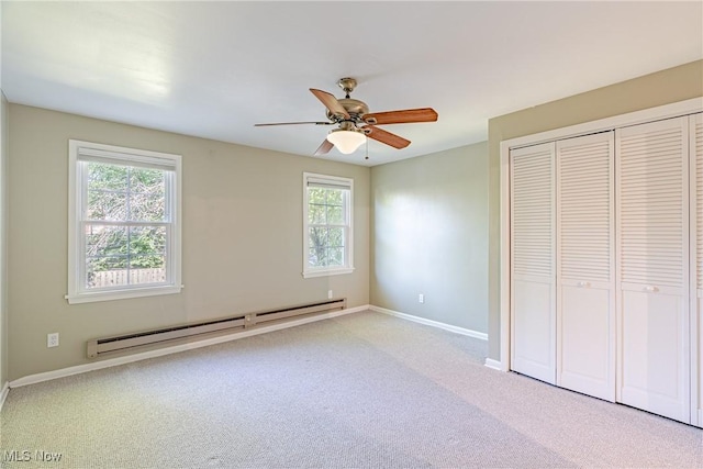 2383 Saybrook Rd, University Heights, OH 44118 - unfurnished bedroom featuring a baseboard heating unit, carpet, multiple windows, and a closet