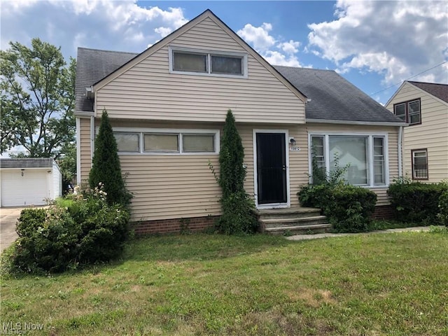 19812 Stockton Ave, Maple Heights, OH 44137 - view of front of property with a shingled roof, a front lawn, a garage, and concrete driveway