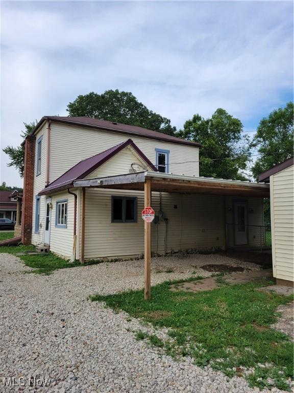 217 E 4th St, Warsaw, OH 43844 - rear view of property with an attached carport