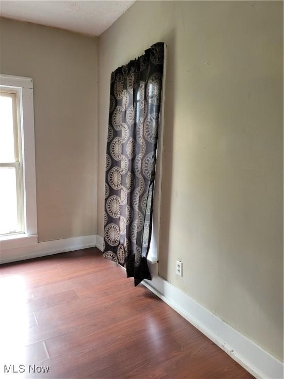217 E 4th St, Warsaw, OH 43844 - empty room with wood finished floors and baseboards