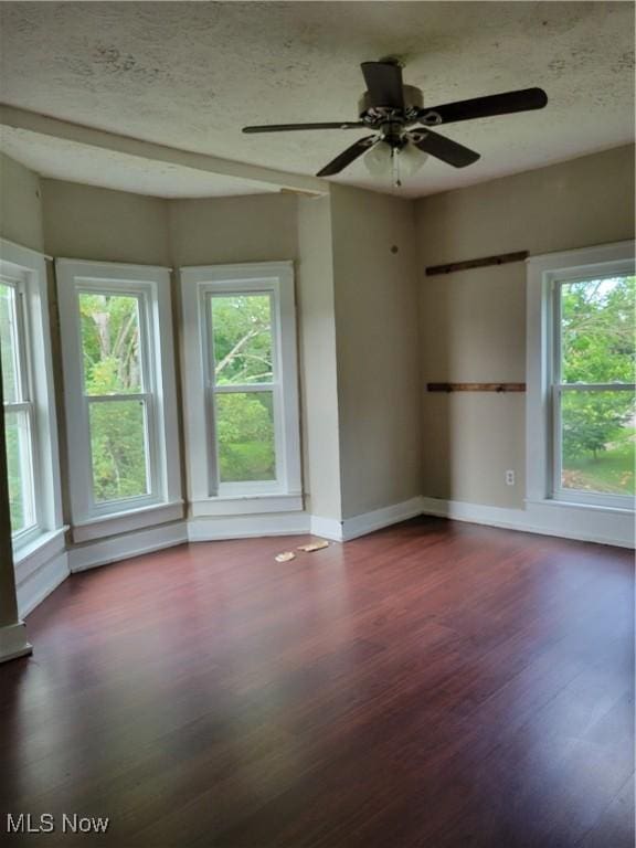 217 E 4th St, Warsaw, OH 43844 - unfurnished room featuring wood finished floors, healthy amount of natural light, ceiling fan, and a textured ceiling