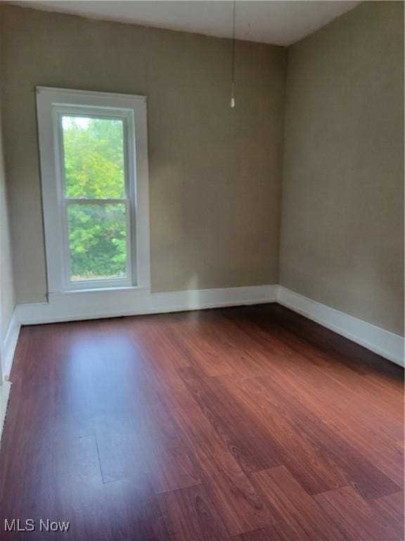 217 E 4th St, Warsaw, OH 43844 - empty room featuring dark wood-style flooring and baseboards