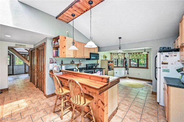 1173 Ridge Rd, Salem, OH 44460 - kitchen with black appliances, vaulted ceiling, dark countertops, light brown cabinetry, and decorative light fixtures