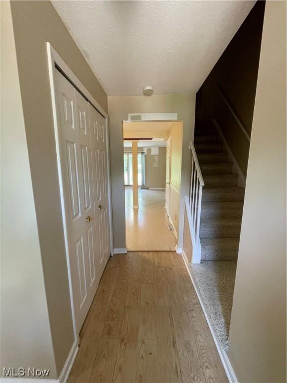 6466 Concord Rd Unit M4, Parma, OH 44134 - hallway with hardwood / wood-style floors, a textured ceiling, and stairs