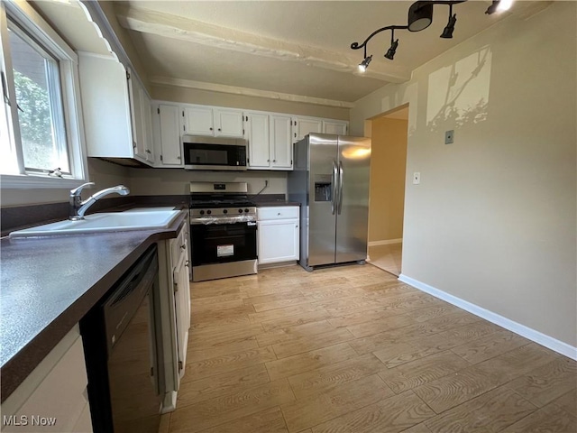 6466 Concord Rd Unit M4, Parma, OH 44134 - kitchen with stainless steel appliances, dark countertops, white cabinets, and light wood-style flooring