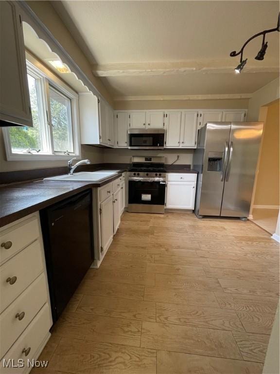 6466 Concord Rd Unit M4, Parma, OH 44134 - kitchen with stainless steel appliances, dark countertops, light wood-style flooring, and white cabinetry