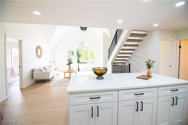 7142 N Oxshire Pl, Concord, OH 44077 - kitchen with light wood-style flooring, light countertops, white cabinetry, recessed lighting, and open floor plan