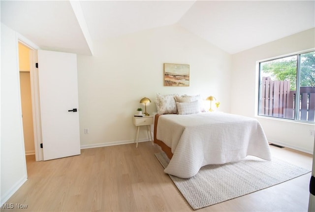 7142 N Oxshire Pl, Concord, OH 44077 - bedroom featuring light wood-style flooring and lofted ceiling