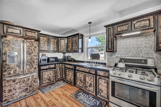 29100 Weber Ave, Wickliffe, OH 44092 - kitchen with stainless steel range with gas stovetop, fridge with ice dispenser, dark countertops, dark brown cabinetry, and light wood finished floors