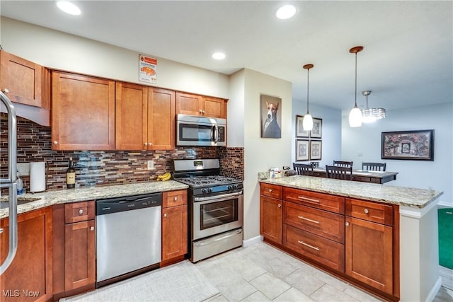 985 Canyon View Rd Unit 204C, Northfield, OH 44067 - kitchen with stainless steel appliances, a peninsula, brown cabinets, tasteful backsplash, and recessed lighting