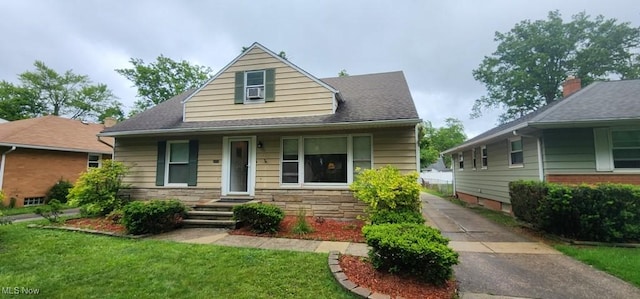 963 Chelston Rd, South Euclid, OH 44121 - bungalow with a front lawn, stone siding, and a shingled roof