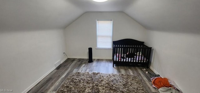 963 Chelston Rd, South Euclid, OH 44121 - unfurnished bedroom with wood finished floors, lofted ceiling, and a nursery area
