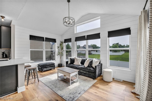1383 Easton Way, Brunswick, OH 44212 - sunroom with a deck, hardwood / wood-style floors, a chandelier, and high vaulted ceiling