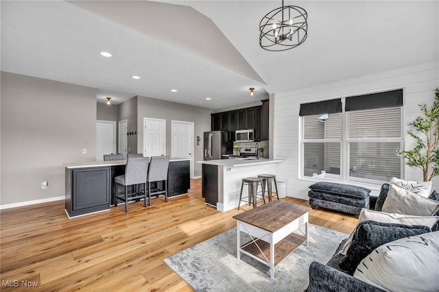 1383 Easton Way, Brunswick, OH 44212 - living room featuring lofted ceiling, a chandelier, light wood-style floors, and recessed lighting