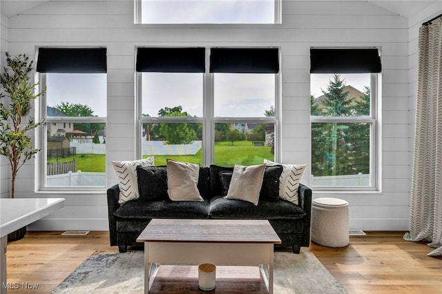 1383 Easton Way, Brunswick, OH 44212 - living room with vaulted ceiling, hardwood / wood-style flooring, and wooden walls