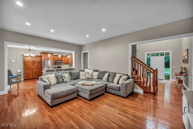7955 Forest Valley Ln, Concord, OH 44077 - living room featuring light wood-style flooring, stairs, recessed lighting, and a chandelier