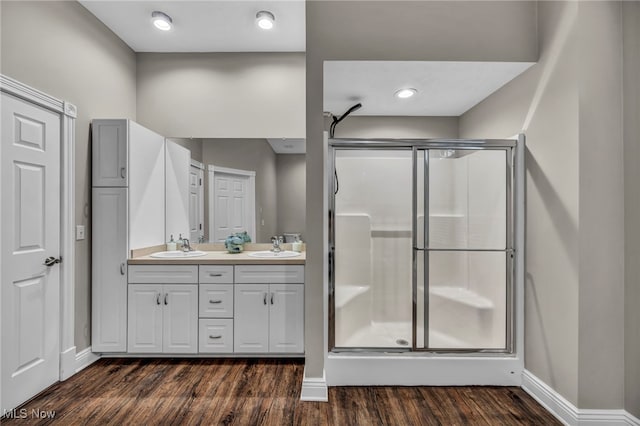 7955 Forest Valley Ln, Concord, OH 44077 - bathroom with a shower stall, double vanity, and wood finished floors