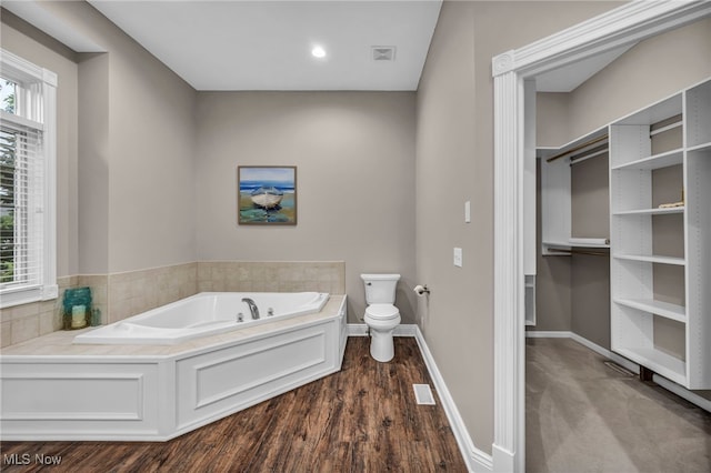 7955 Forest Valley Ln, Concord, OH 44077 - bathroom with a garden tub and wood finished floors