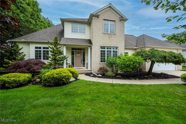 7955 Forest Valley Ln, Concord, OH 44077 - view of front of home featuring a garage, a front yard, driveway, and brick siding