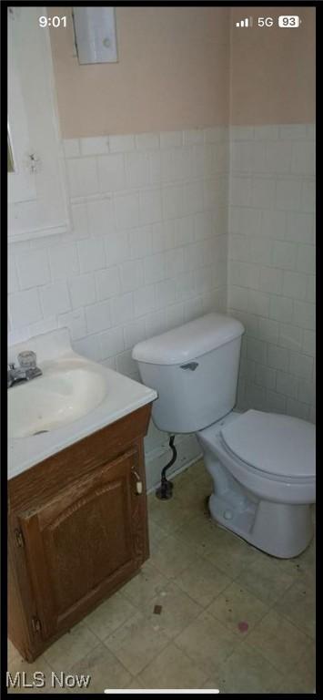 1405 Brandon Ave, Akron, OH 44305 - bathroom featuring tile walls, vanity, wainscoting, and tile patterned floors