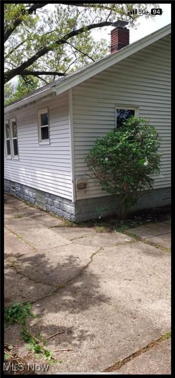 1405 Brandon Ave, Akron, OH 44305 - view of side of home with a chimney and a patio area