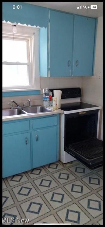 1405 Brandon Ave, Akron, OH 44305 - kitchen featuring blue cabinetry, white range with electric cooktop, and light countertops
