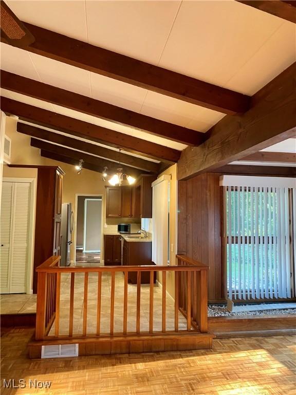 17079 Cats Den Rd, Chagrin Falls, OH 44023 - kitchen with appliances with stainless steel finishes, beam ceiling, wooden walls, and a peninsula