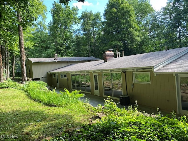 17079 Cats Den Rd, Chagrin Falls, OH 44023 - back of property with a shingled roof and a chimney