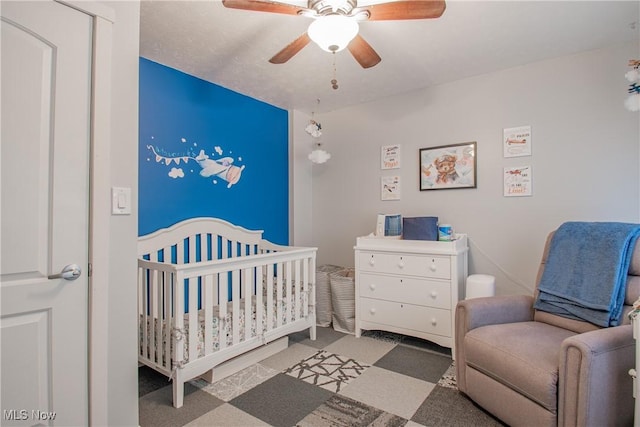 2262 Pine Top Ct Unit 31, Akron, OH 44319 - bedroom featuring a crib, ceiling fan, and carpet
