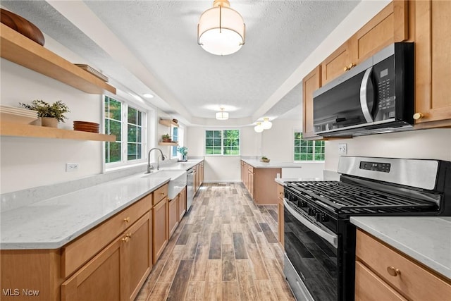 3695 S Hametown Rd, Norton, OH 44203 - kitchen with appliances with stainless steel finishes, open shelves, light wood-type flooring, and light stone countertops