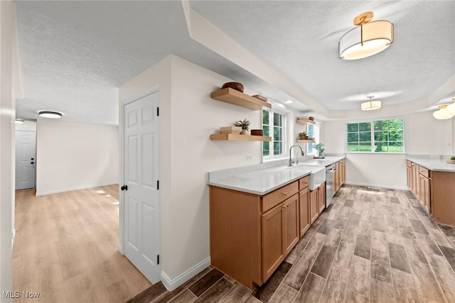 3695 S Hametown Rd, Norton, OH 44203 - kitchen featuring a textured ceiling, dishwasher, light wood-style flooring, open shelves, and light countertops